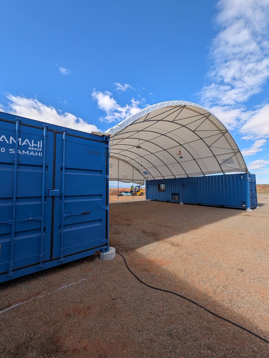 Dome shelter workshop installed between the container line at the Cue site