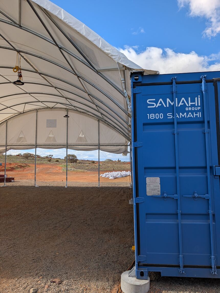 Dome shelter spanning the clear gap between two shipping containers